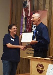 LaNetta Jarrett receives her Competent Communicator award from Charles Beasley.